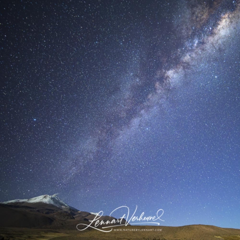Milky Way over smoking volcano near Guallatiri in Chile